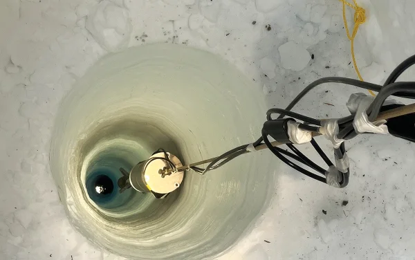 Буровая установка в ледяной скважине с оборудованием для исследований.