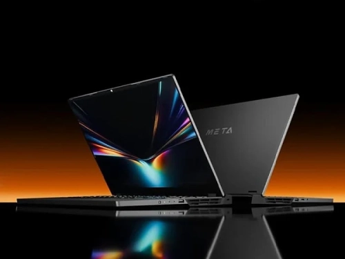 Ноутбук Meta с открытым экраном на черно-оранжевом фоне.
