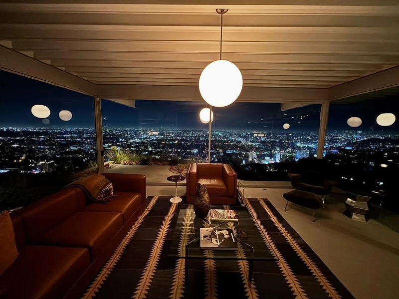 The living room of the Stahl House overlooking Los Angeles at night.