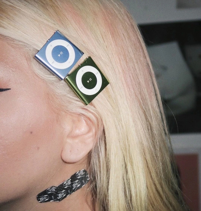 iPod Shuffles worn as hair clips, a Y2K fashion trend. Photo by vic cammie.