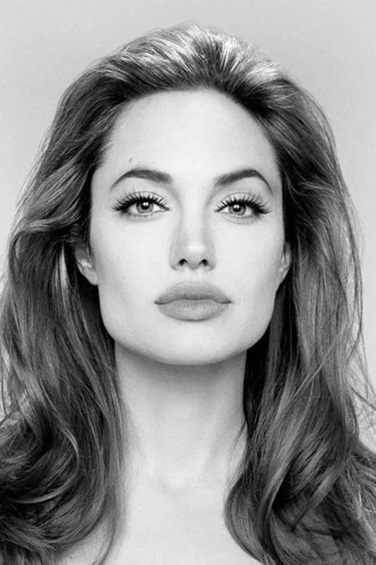 a black and white photo of a woman with long hair