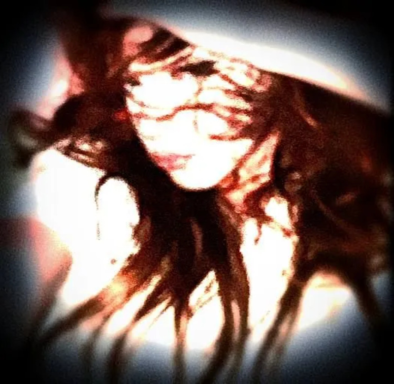 a blurry photo of a woman with long hair