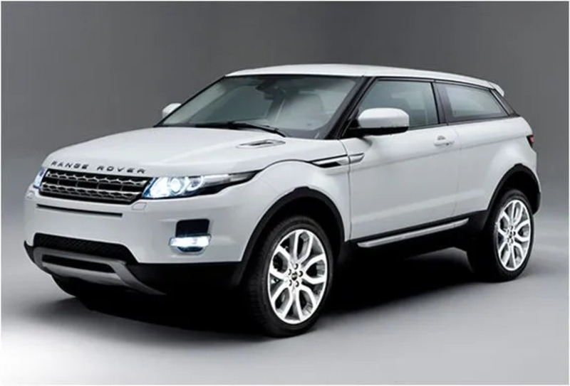 the white range rover is parked in an empty room with gray walls and flooring