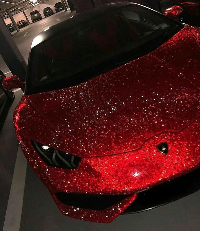 a red sports car covered in glitter next to a parking meter