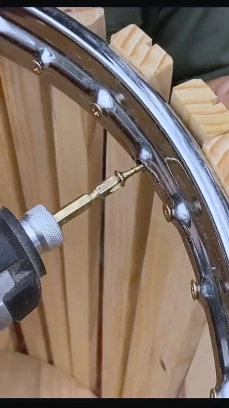 a close up of a wheel on a wooden chair with screwdrivers in it