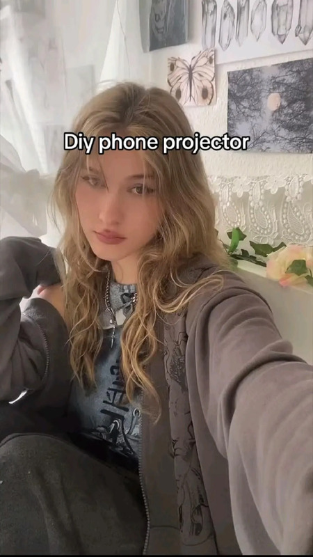 a woman is taking a selfie with her cell phone in front of her face