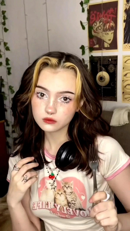a girl with headphones on holding a pair of scissors