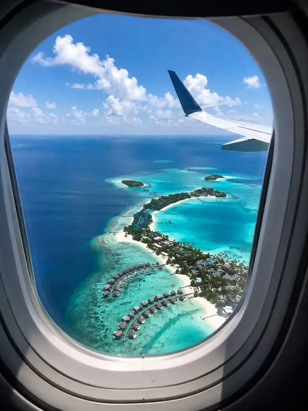 an airplane window looking out at the ocean