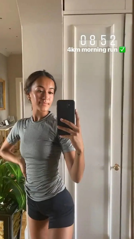 a woman taking a selfie with her cell phone in front of a mirror,