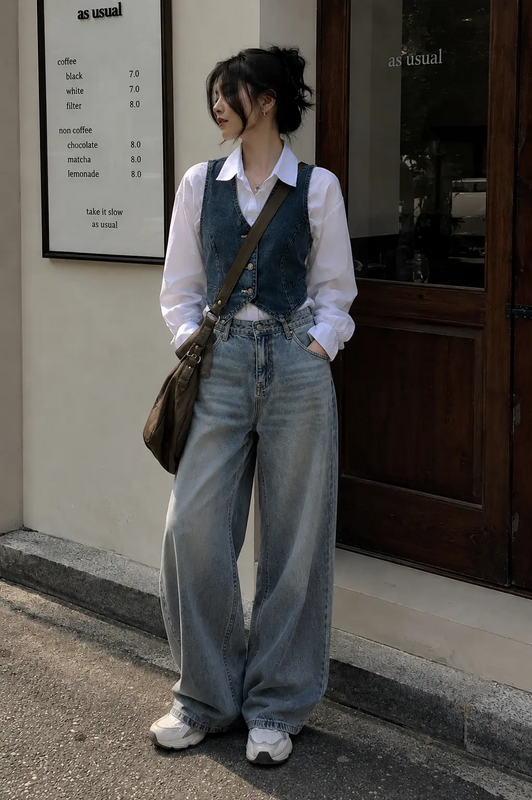 Serving soft cool-girl vibes with a crisp white shirt layered under a denim vest, oversized baggy jeans, and a neutral sling bag for that effortlessly aesthetic Pinterest look. Perfect for café dates, college fits, casual outings, or everyday stre...