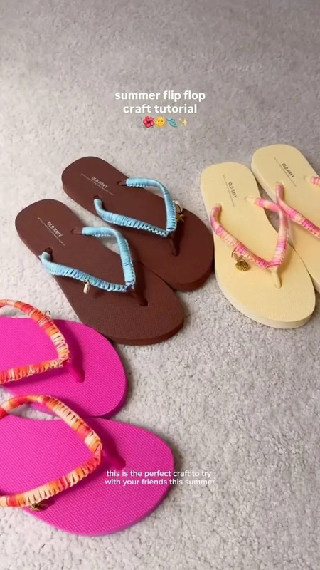 four pairs of flip flops are laying on the floor
