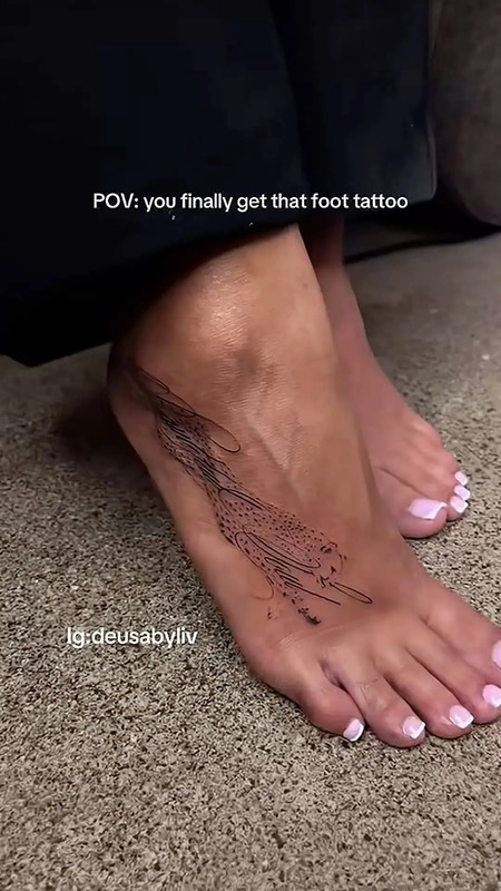 a woman's foot with tattoos on it and the words pov you finally get that foot tattoo