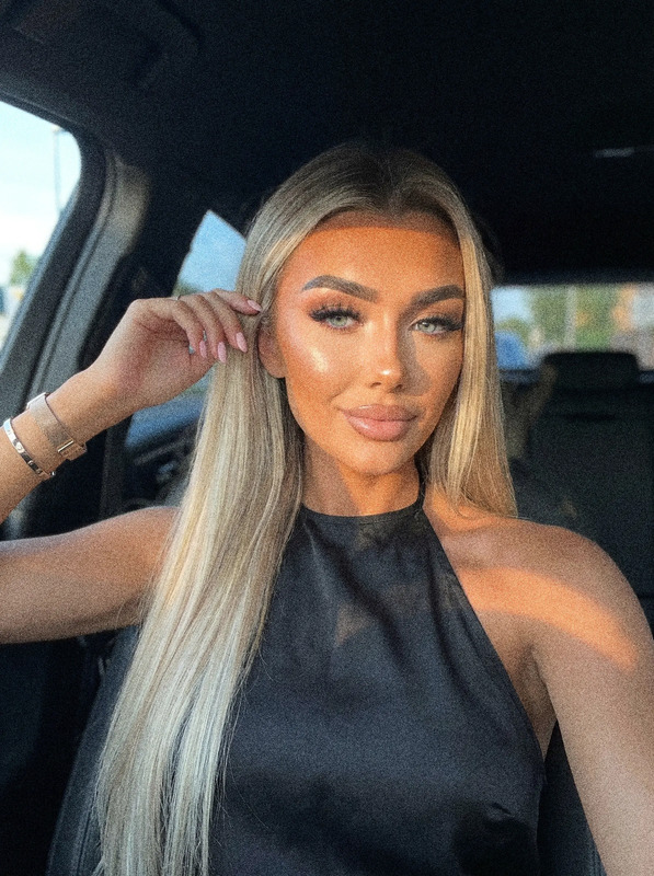 a woman sitting in the back seat of a car