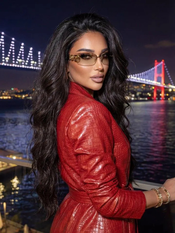 a woman in a red leather jacket and sunglasses