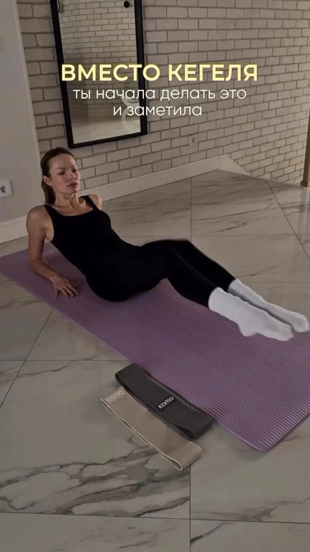 a woman laying on top of a yoga mat