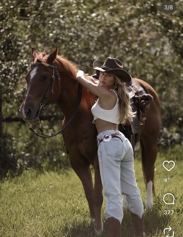 a beautiful young woman standing next to a brown horse