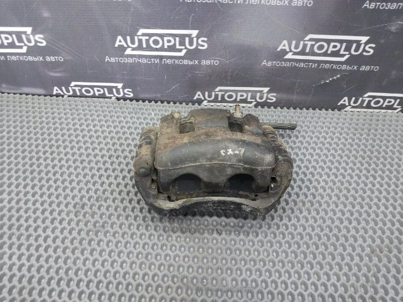 Суппорт тормозной передний левый Mazda CX7 2.3