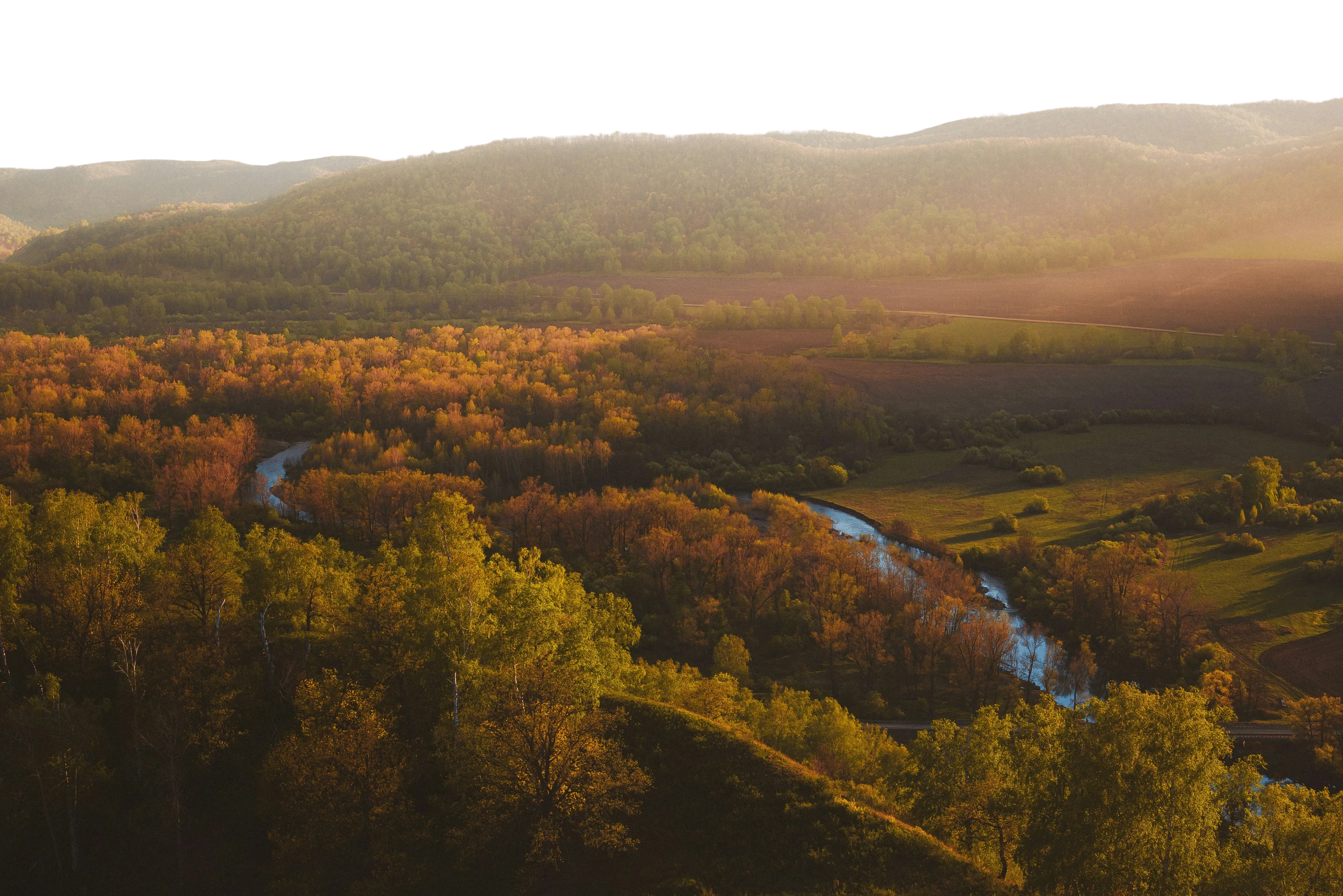 Distant Russian mountains and forest at sunset
