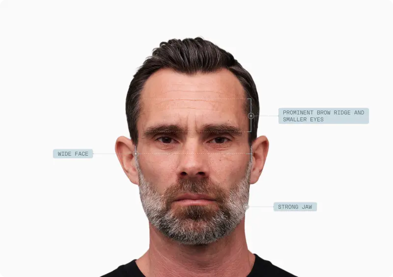 Front portrait of a man with prominent brow, wide face and strong jaw called out as masculine traits