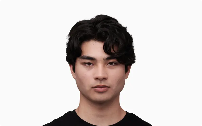 Front portrait of a young adult man with even skin and bright sclera as a youthfulness reference