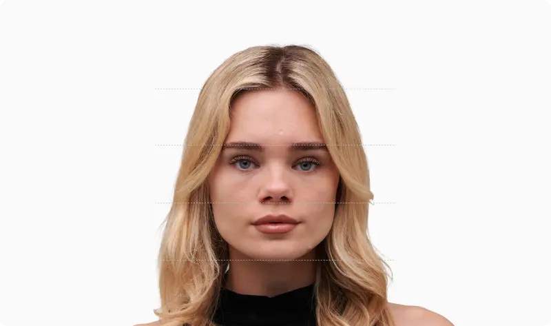 Front portrait of a blonde woman with the face divided into vertical thirds by dotted horizontal lines