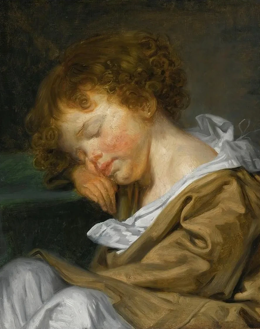 A Boy Asleep On A Table