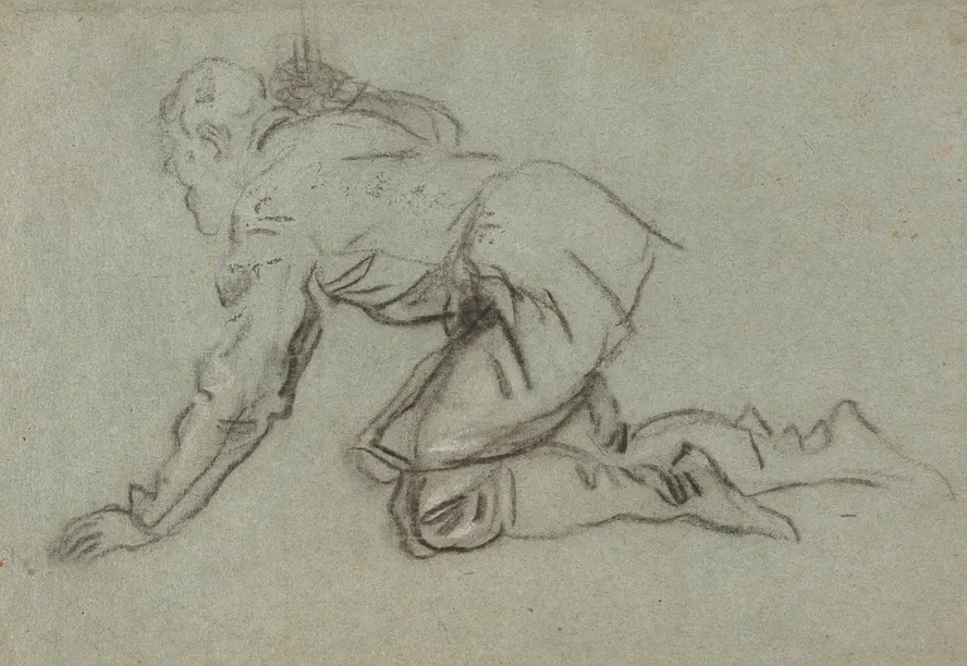 A Kneeling Man Holding a Staff