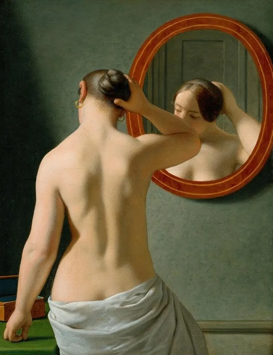 A Nude Woman Doing Her Hair Before A Mirror