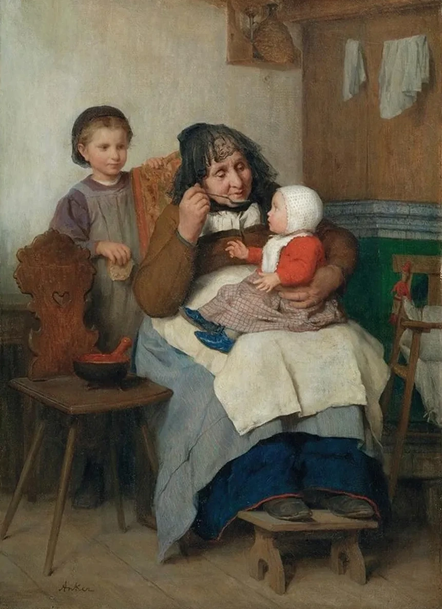 Grandmother Spooning The Soup To Her Grandchild