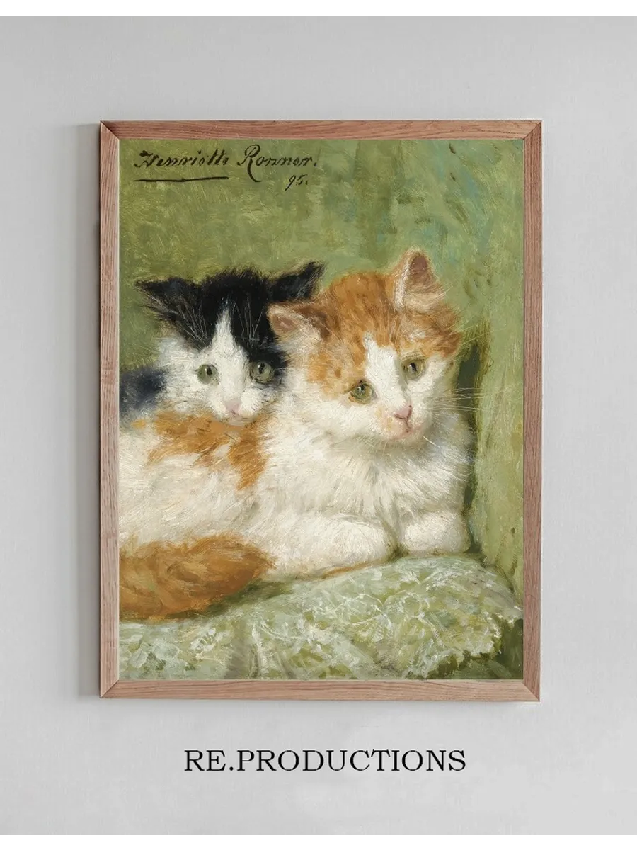 Two Kittens Sitting On A Cushion