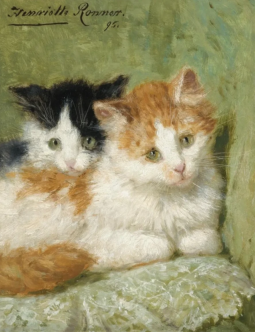Two Kittens Sitting On A Cushion