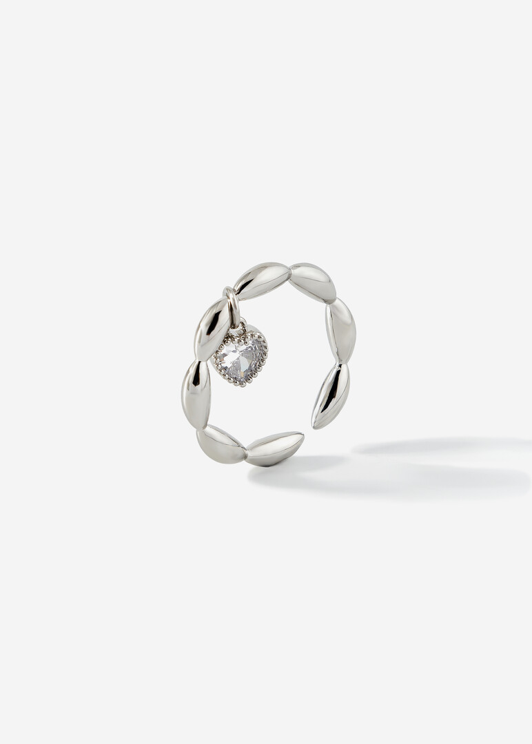 silver ring with a heart pendant