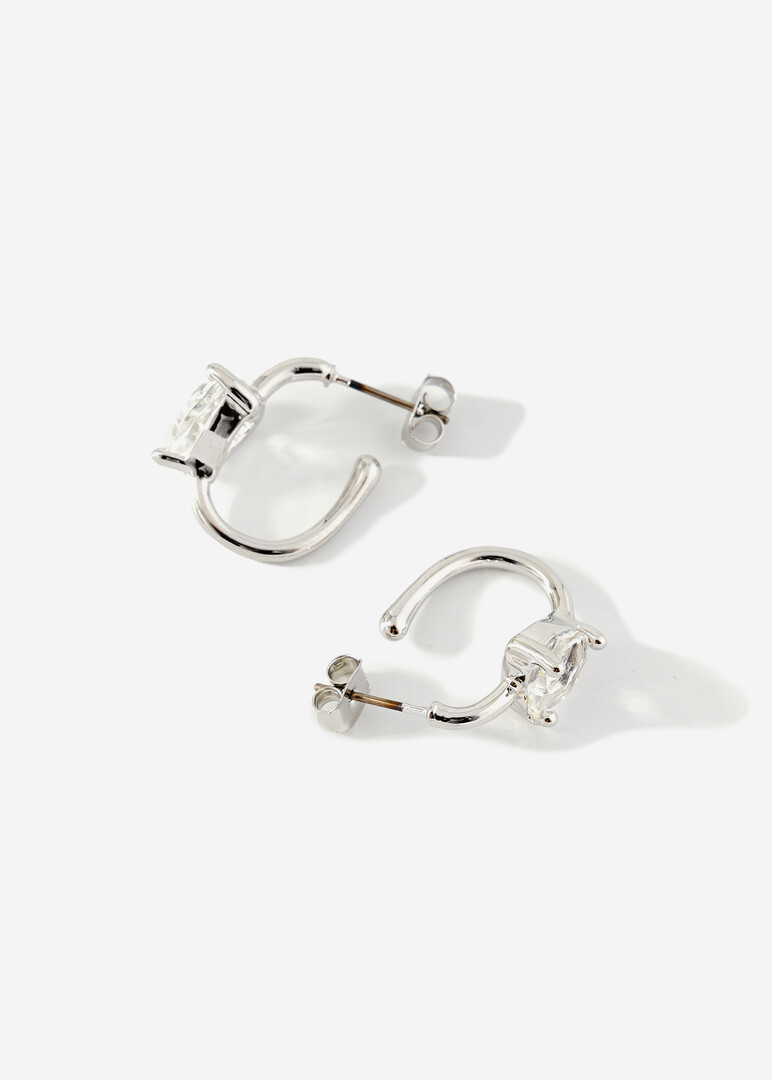 silver hoop earrings with crystals in the shape of hearts