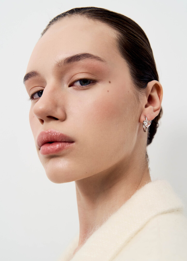 silver hoop earrings with crystals in the shape of hearts