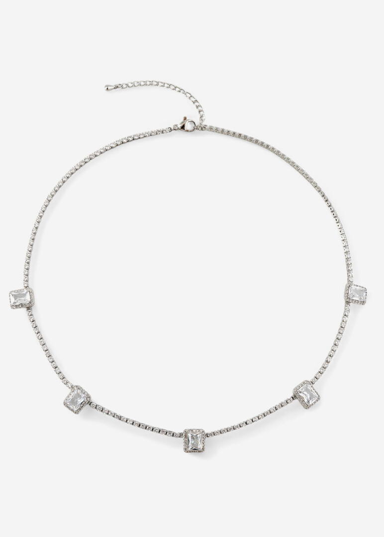 a silver thin necklace with a path of crystals