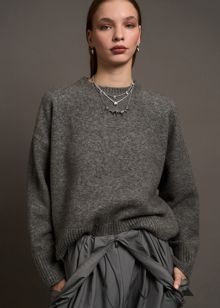 a silver thin necklace with a path of crystals
