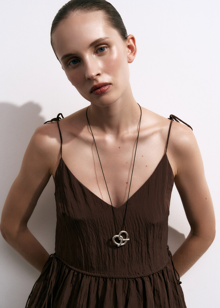 silver necklace on a cord «A Family-Sized Pretzel»
