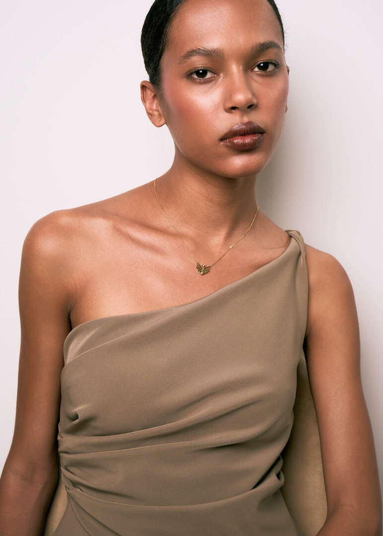 gold pendant on a thin chai