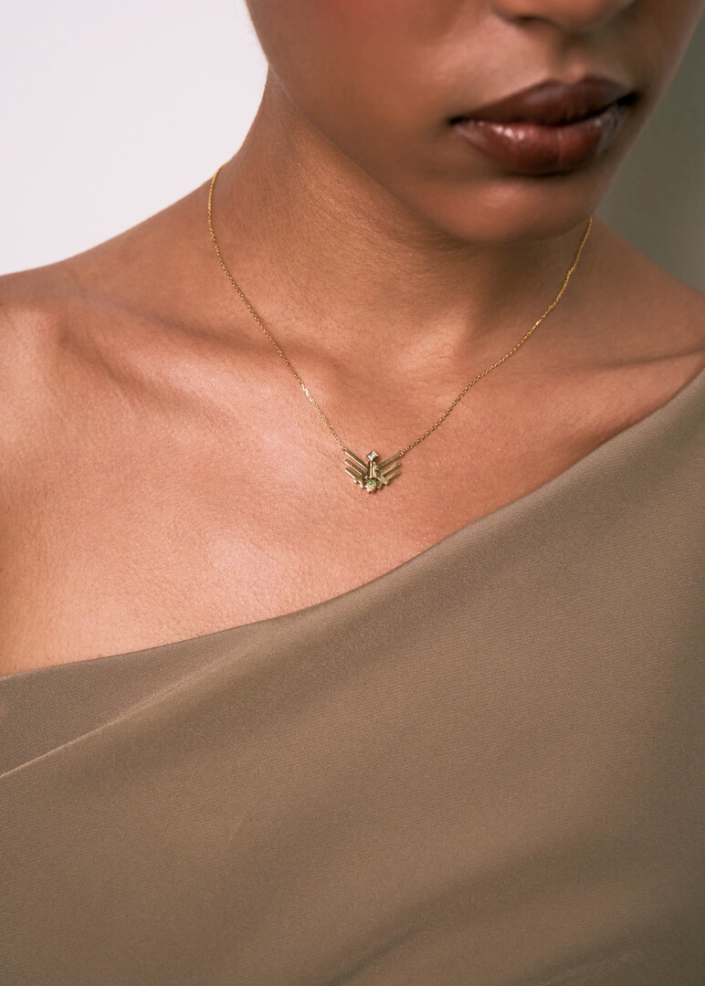 gold pendant on a thin chai