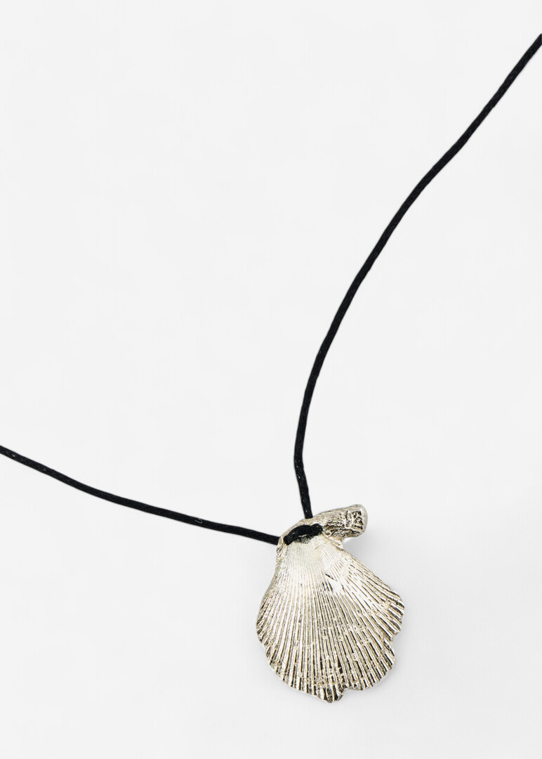 Necklace made of silver with a large seashell on a cord