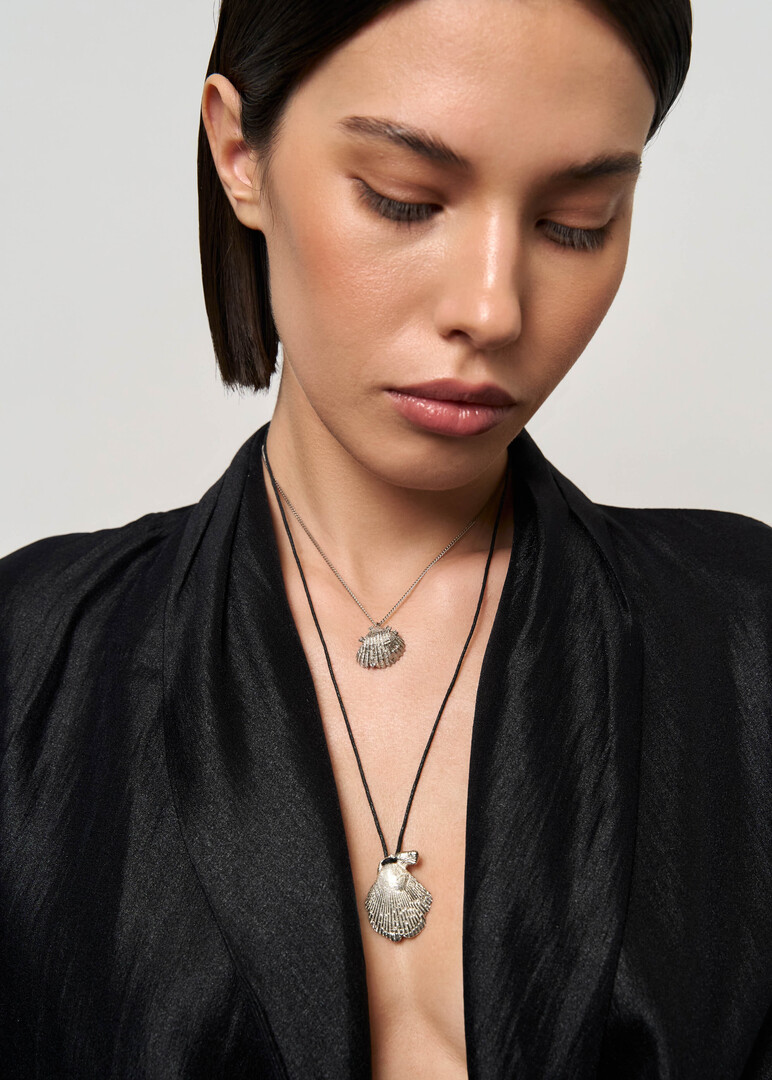 Necklace made of silver with a large seashell on a cord