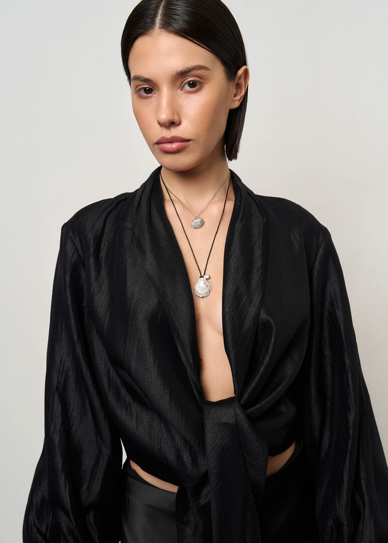 Necklace made of silver with a large seashell on a cord