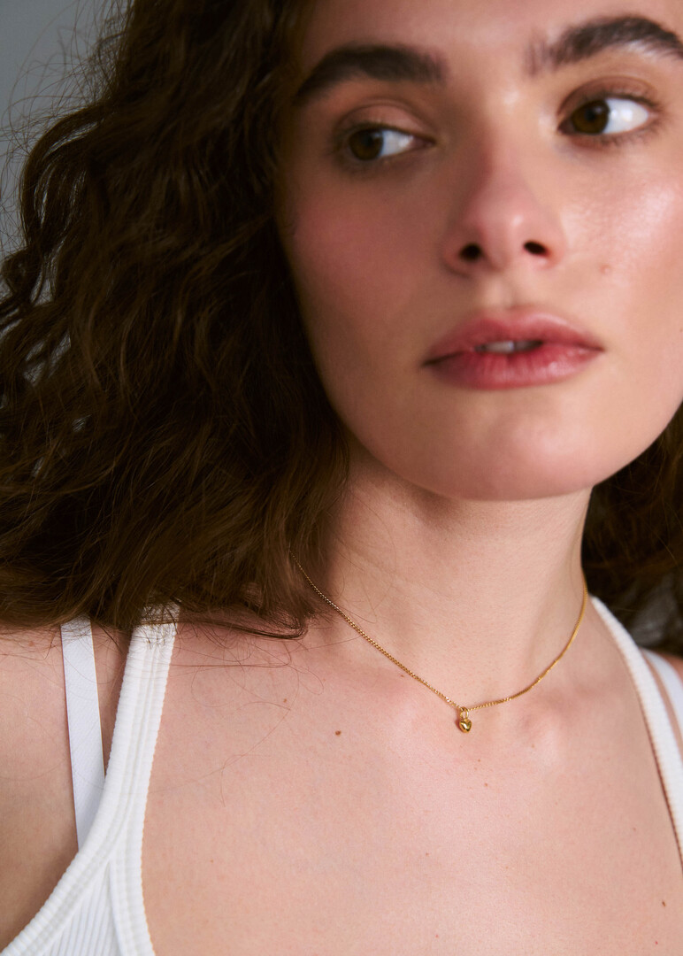 gold plated silver necklace with a small heart