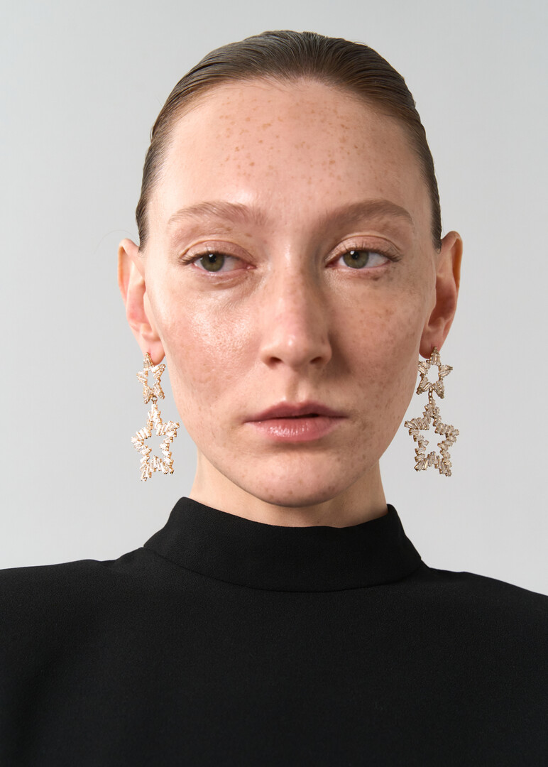 Gold earrings made of two stars with crystals