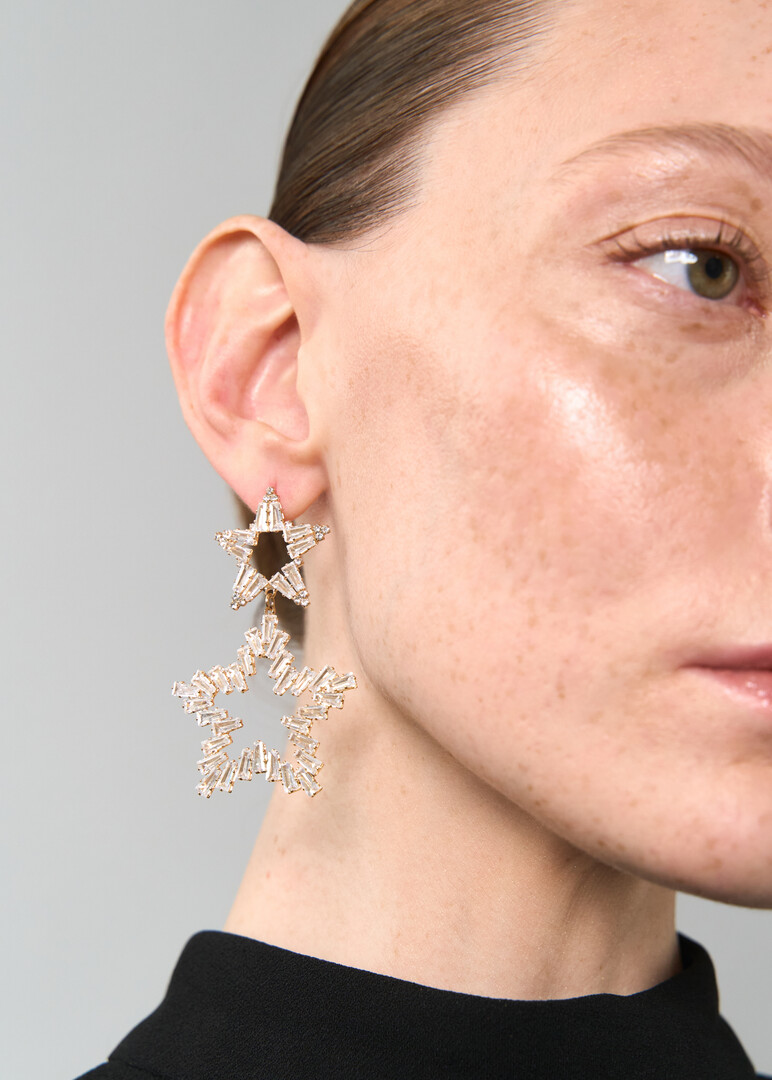 Gold earrings made of two stars with crystals