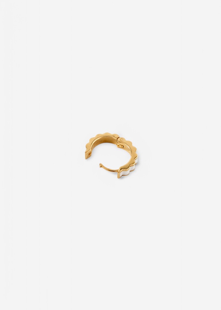 gold Memphis piercing with white enamel