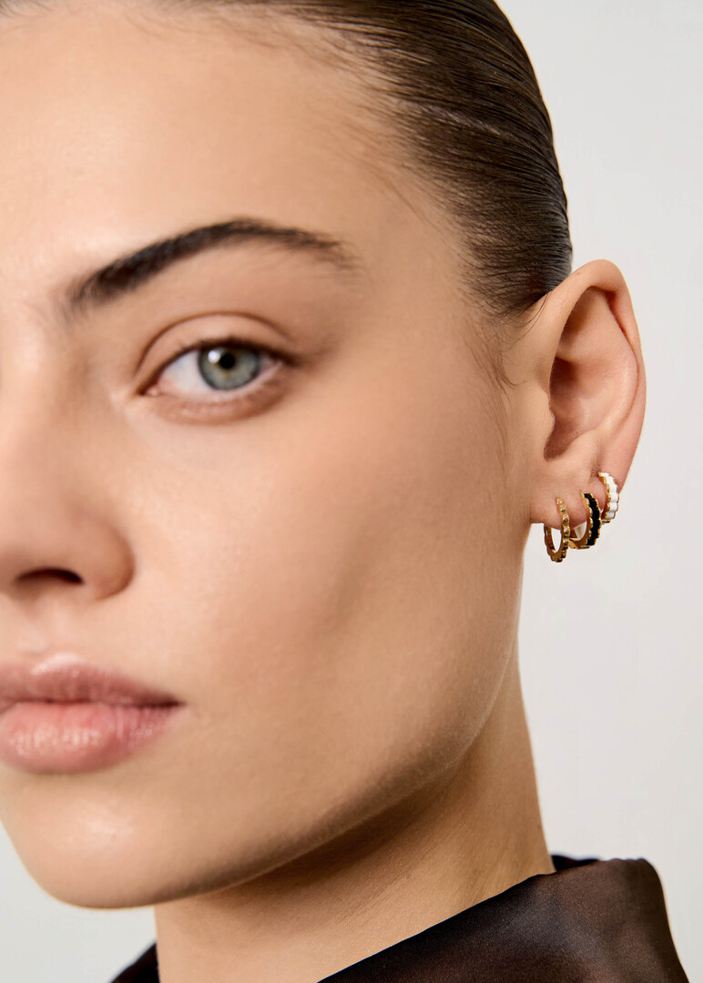 gold Memphis piercing with white enamel