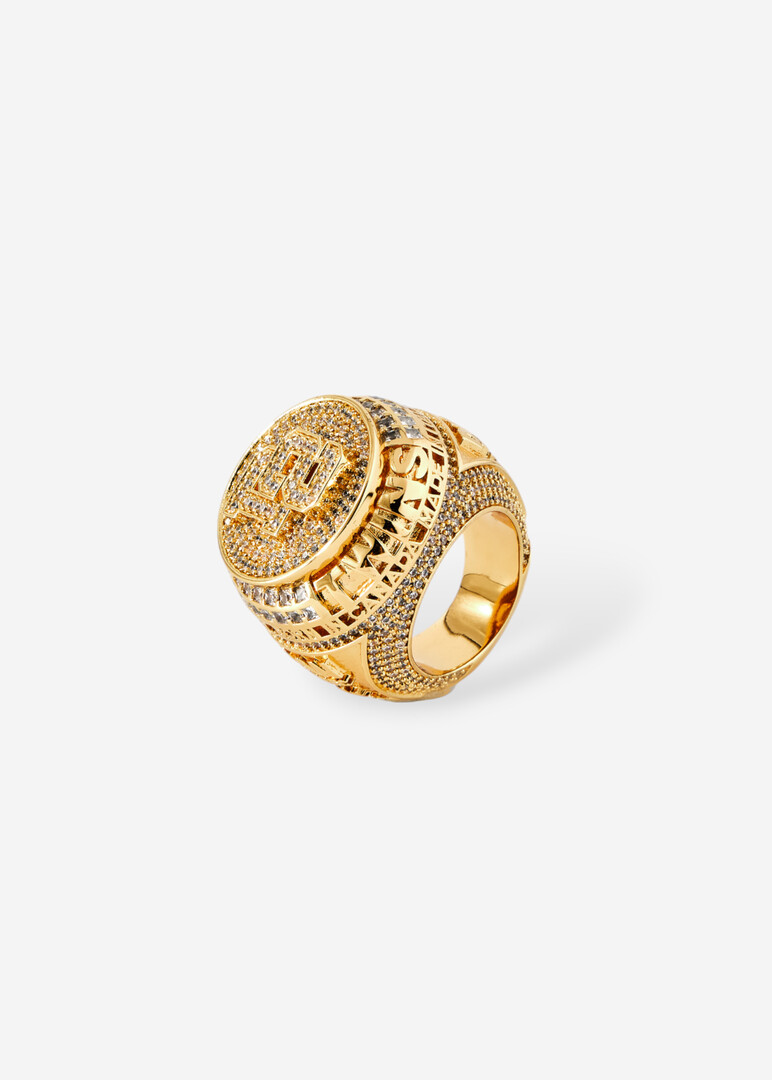 Round golden seal with engraved logo and crystals