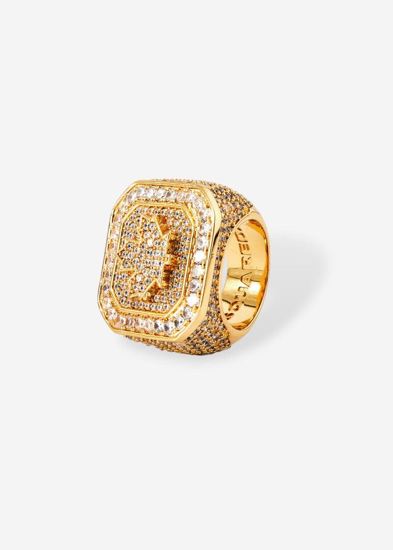 Square golden seal with engraved logo and crystals