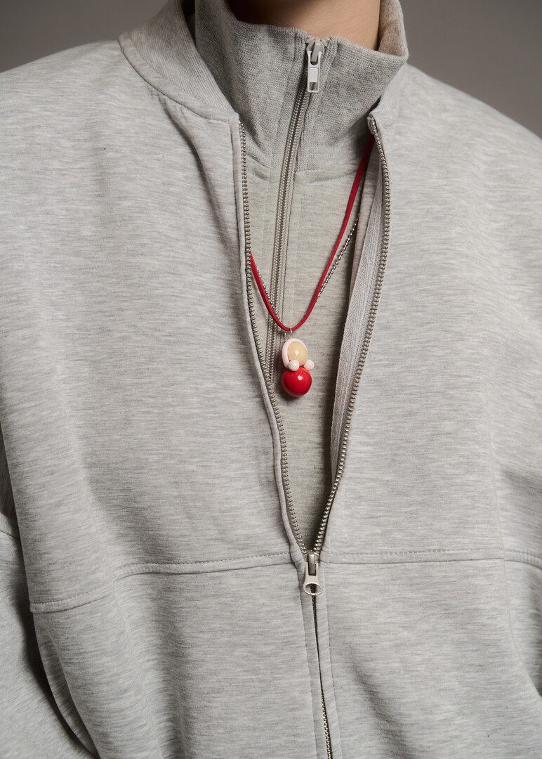 Tumbler pendant on a stainless steel chain complete with a red lace